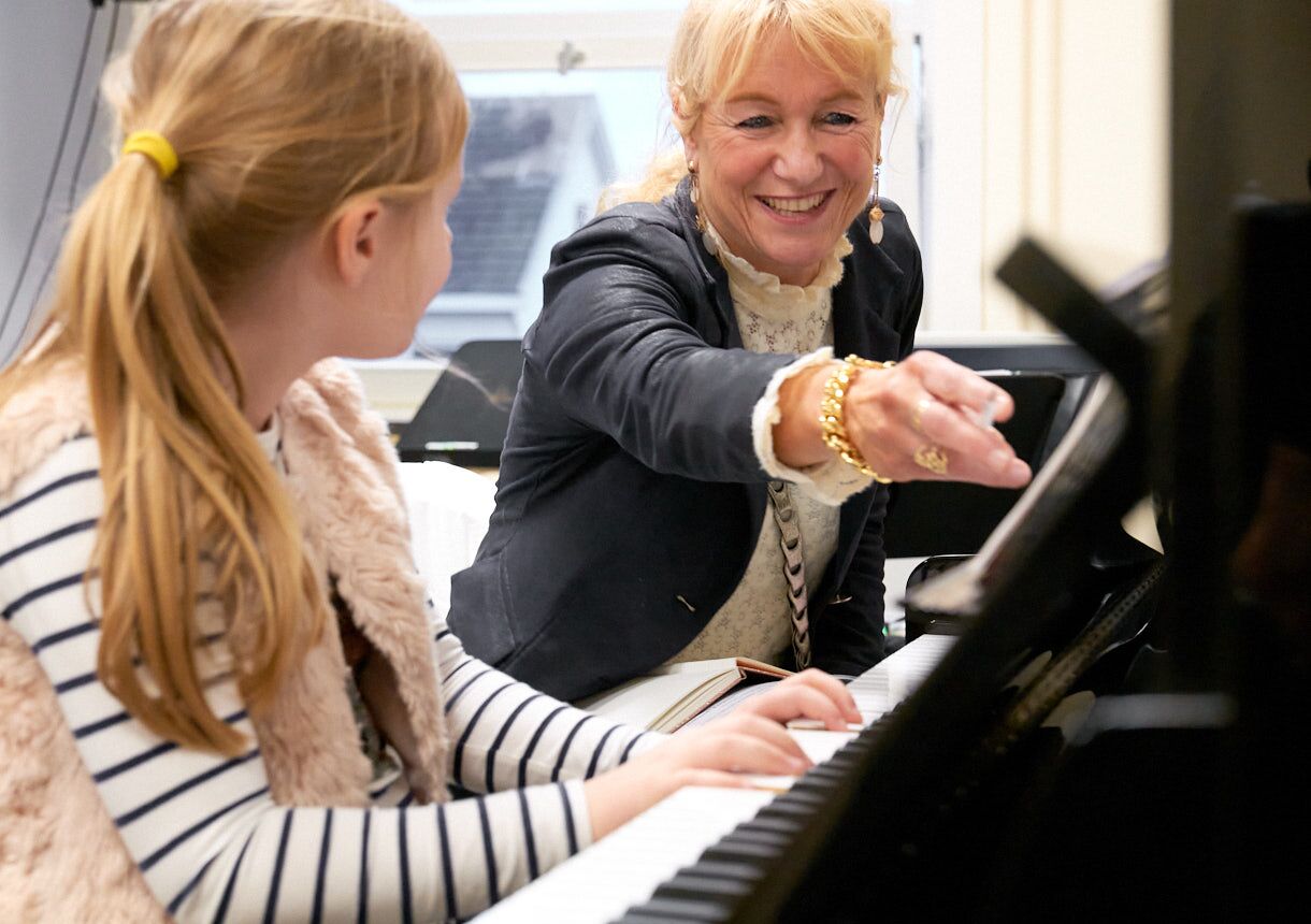Leerling krijgt pianoles
